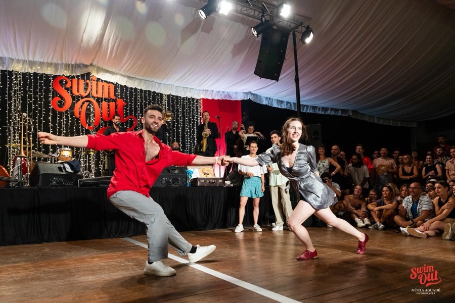Ionuț Băjescu dancing Lindy Hop with a partner on stage at the Swim Out festival
